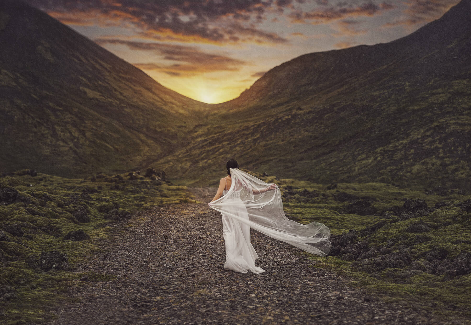 Beautiful bride with sunset and mountains in the background